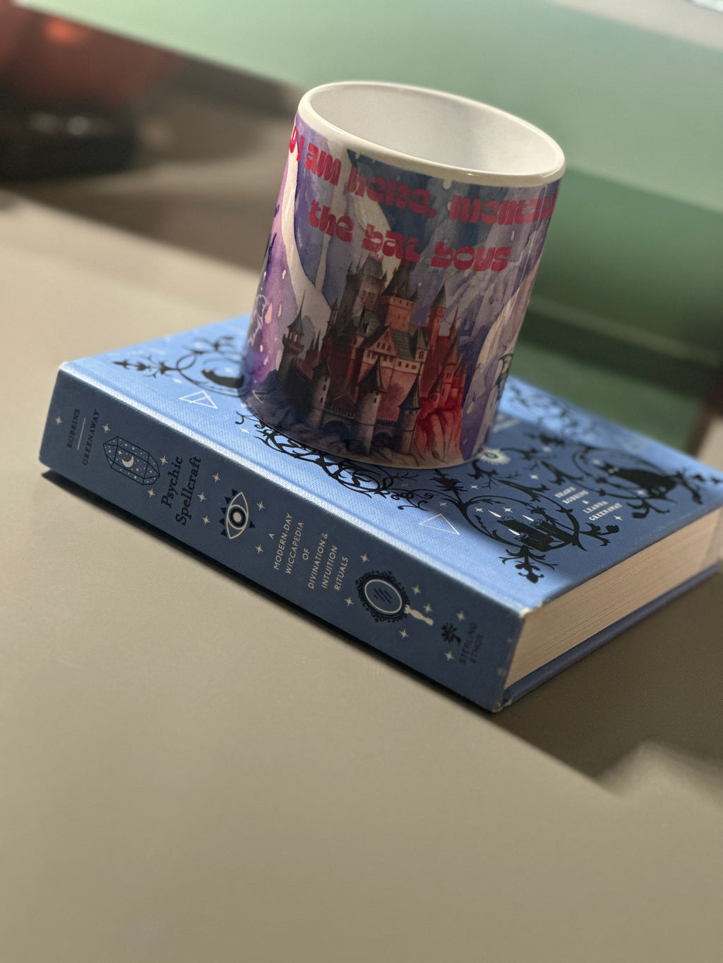 Angled view of the Bat Boys mug showing the castle illustration and bold red quote text on a deep purple background