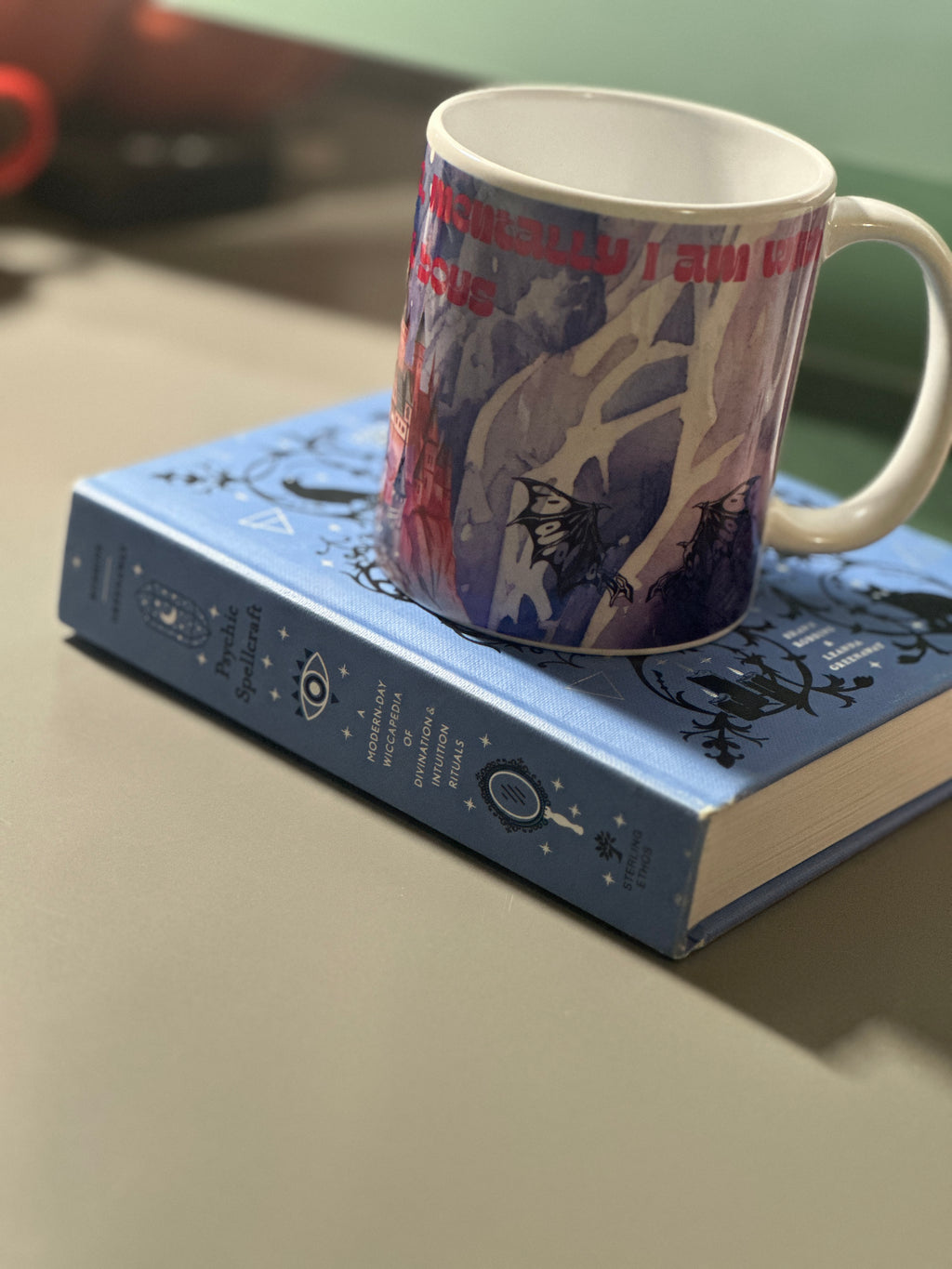 Side view of the fantasy mug showing bat illustrations and moody purple wrap-around print